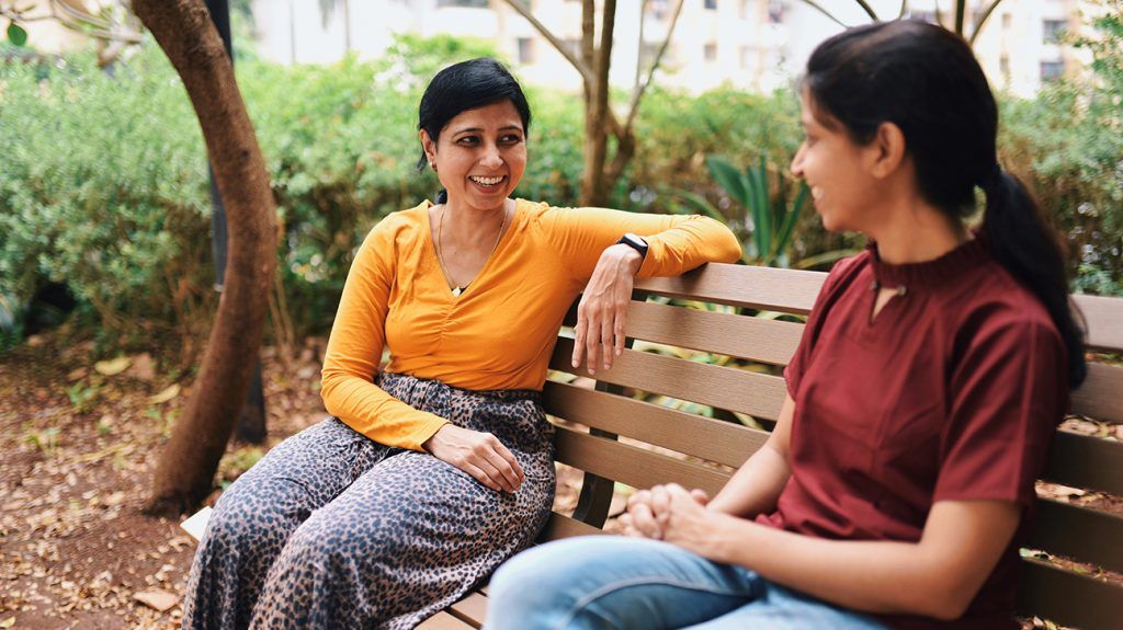 friends chatting on a park bench