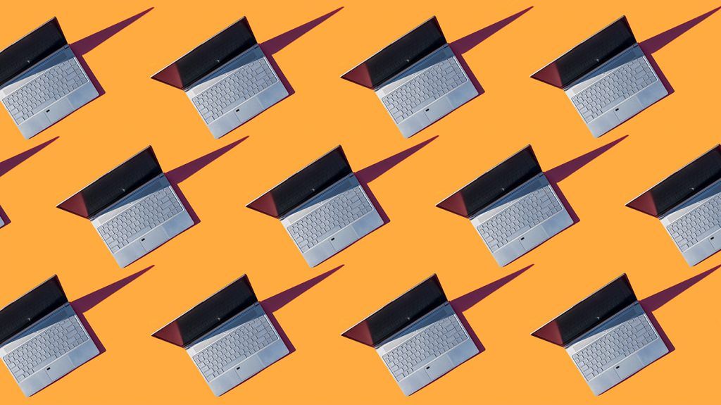 Rows of open laptops on an orange background