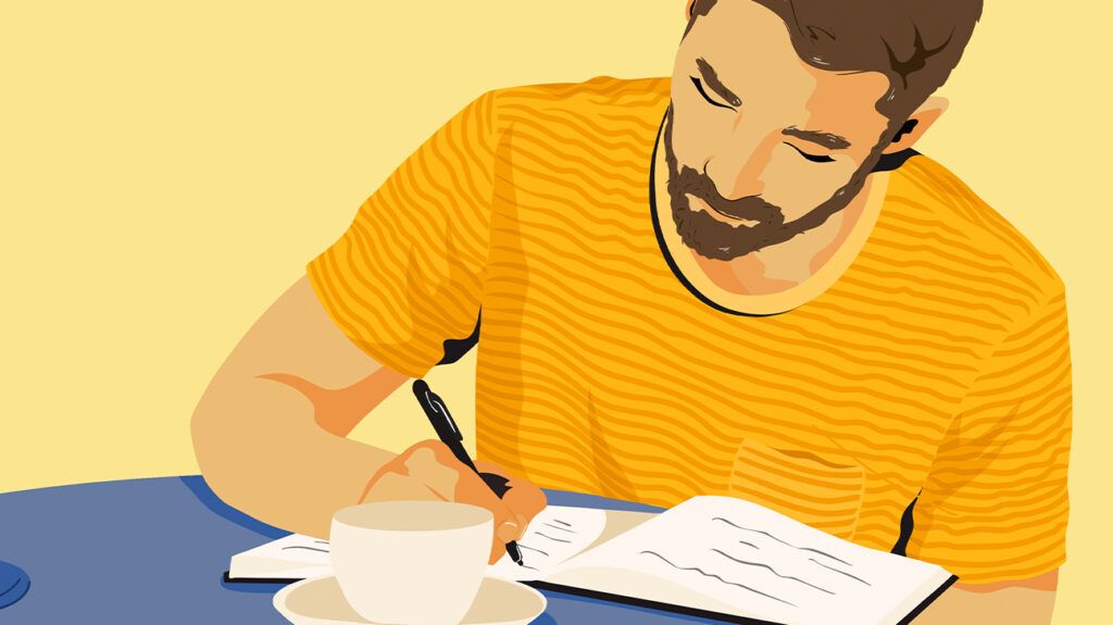 Man sitting at a table journaling